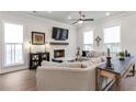 Bright living room featuring a fireplace, large windows, and comfortable seating at 134 Everley Walk, Alpharetta, GA 30009