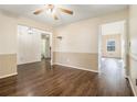 Neutral-toned dining room with stylish wood floors, wainscoting, and ample natural light through window at 1698 Bennett Dr, Mcdonough, GA 30253