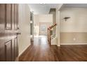 Inviting foyer with hardwood floors, neutral walls, and staircase leading to the upper level, providing a warm welcome at 1698 Bennett Dr, Mcdonough, GA 30253