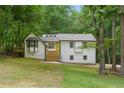 Charming two-story home with a white exterior, black trim, and a bright yellow front door at 3713 Brigantine Ct, Acworth, GA 30102