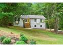 Charming two-story home with a white exterior, black trim, and landscaped front yard at 3713 Brigantine Ct, Acworth, GA 30102