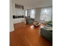 Bright living room featuring hardwood floors, comfortable seating, and large windows offering city views at 57 Forsyth Nw St # 11B, Atlanta, GA 30303