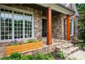 Inviting stone porch with wooden columns and a decorative flower box, adding to the home's curb appeal at 2260 Falkirk Pointe Dr, Marietta, GA 30062