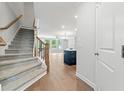 Inviting foyer featuring a staircase and hardwood flooring, offering a glimpse into the spacious living area at 233 Retreat Ln, Canton, GA 30114
