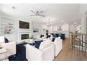 Bright living room with fireplace, built-ins, and open floor plan connecting to a modern kitchen at 233 Retreat Ln, Canton, GA 30114