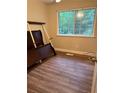 This bedroom features wood flooring and a window at 405 Fairburn Sw Rd # 64, Atlanta, GA 30331