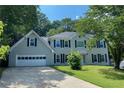 Traditional two-story home with a two-car garage, black shutters, and a well-manicured front lawn at 4635 Tims Pl, Snellville, GA 30039