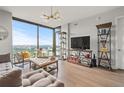 Spacious living room featuring a large window, hardwood flooring, and tasteful furnishings at 270 17Th Nw St # 2804, Atlanta, GA 30363