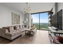 Cozy living room with a comfortable couch, decorative art, and large windows with a scenic view at 270 17Th Nw St # 2804, Atlanta, GA 30363