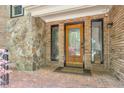 A close-up of a well-maintained front door with sidelights, brickwork, and stone accents, creating a warm entry at 3493 Wood Acres Blvd, Duluth, GA 30096