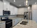 Well-equipped kitchen with stainless steel appliances and granite countertops at 5522 Cosimo Rd, Fairburn, GA 30213