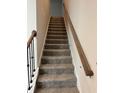 Carpeted staircase with wooden handrails leading to the upper level at 5522 Cosimo Rd, Fairburn, GA 30213