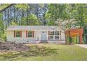 Cozy home featuring decorative shutters, well-maintained lawn and ample shade trees at 4201 Regal Ridge Rd, Austell, GA 30106