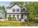 Charming two-story home with black trim, white painted brick, landscaped yard and manicured shrubbery at 1410 Eastland Rd Se Rd, Atlanta, GA 30316