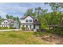 Charming white house with dark trim, well-maintained lawn, and mature trees, offering a welcoming appeal at 1410 Eastland Rd Se Rd, Atlanta, GA 30316