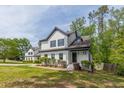Inviting two-story house featuring a white exterior, dark shutters, and professionally landscaped front yard at 1410 Eastland Rd Se Rd, Atlanta, GA 30316