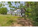 Beautiful home on a lush green lawn, with mature trees providing shade and curb appeal at 1410 Eastland Rd Se Rd, Atlanta, GA 30316