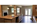 Open kitchen view into living area with granite counters and stainless sink at 3272 Baylor Cir, Mcdonough, GA 30253