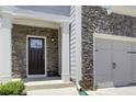 Close up of a front door and stone-accented exterior, offering great curb appeal at 550 Constellation Overlook Sw, Atlanta, GA 30331