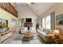 Bright living room featuring vaulted ceilings, a stone fireplace, and plush neutral-toned furnishings at 10 Briarcliff Pl, Stockbridge, GA 30281