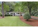 Well-maintained one-story home surrounded by lush greenery and a neatly landscaped yard at 3357 Pretty Branch Se Dr, Smyrna, GA 30080