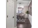 Hallway view to dining room features modern chandelier and wainscoting, enhancing the home's appeal at 955 Juniper Ne St # 3331, Atlanta, GA 30309