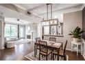 Open-concept living room featuring dark wood floors, fireplace, and dining area under modern lighting at 955 Juniper Ne St # 3331, Atlanta, GA 30309