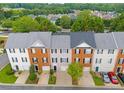 Aerial view of townhomes showcasing rooftops, driveways, landscaping, and a neighborhood setting at 5357 Beaver Br, Norcross, GA 30071