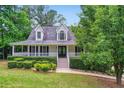 Charming two-story home featuring a welcoming front porch and manicured landscaping at 212 Warrenton Dr, Douglasville, GA 30134