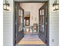 Inviting foyer with hardwood floors, vintage decor, and a view into the adjacent rooms at 212 Warrenton Dr, Douglasville, GA 30134