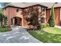View of the exterior brick home featuring an attached two-car garage and mature landscaping at 5121 Hunters Hill Sw Cv, Lilburn, GA 30047