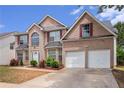 Beautiful brick home with two-car garage, manicured lawn, and symmetrical facade at 3740 Arminto Dr, Ellenwood, GA 30294