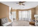 Cozy living room area with large bay window and comfortable seating arrangement at 3740 Arminto Dr, Ellenwood, GA 30294
