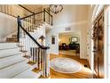 Grand foyer with a curved staircase, hardwood floors, and a view into the living room at 8480 Valemont Dr, Sandy Springs, GA 30350