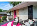 Inviting covered front porch with seating area, plants, and stylish decorations at 240 W Lake Nw Dr, Atlanta, GA 30314