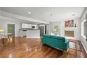 Open-concept living room featuring hardwood floors, a brick fireplace, and plenty of natural light at 240 W Lake Nw Dr, Atlanta, GA 30314