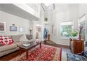 Cozy living room with hardwood floors, neutral walls, large windows, and comfortable seating at 1901 Brittania Cir, Woodstock, GA 30188