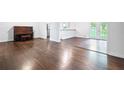 View of hardwood floors in the spacious living room with french doors and natural light at 1971 Hooper St, Decatur, GA 30032