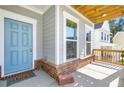 Inviting front porch with blue door, brick accents, and a cozy welcome mat at 411 Riverclub Rd, Acworth, GA 30101