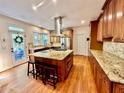 Open kitchen featuring a large island, stainless steel appliances, and granite countertops at 4265 Lansmoore Xing, Suwanee, GA 30024