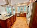 Bright, updated kitchen with stainless steel appliances, an island gas cooktop, and eat in area at 4265 Lansmoore Xing, Suwanee, GA 30024
