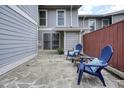 A stone patio features cozy blue chairs, offering an inviting outdoor space at 4977 Meadow Ln, Marietta, GA 30068