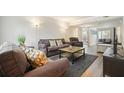 The spacious living room is furnished with plush sofas, complemented by modern decor and lighting at 4977 Meadow Ln, Marietta, GA 30068
