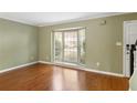 Open living room with hardwood floors, a large bay window, and stairs to the upper level at 136 Peachtree Memorial Nw Dr # Ct-6, Atlanta, GA 30309