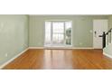Bright living room featuring a large bay window, hardwood floors, and neutral paint at 136 Peachtree Memorial Nw Dr # Ct-6, Atlanta, GA 30309