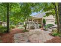 Backyard featuring a patio, landscaped beds, and a screened in porch at 1420 Pilgrim Rd, Cumming, GA 30040