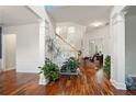 Bright foyer with hardwood floors, white columns, and a staircase with natural light at 3616 Myrtlewood Nw Ct, Kennesaw, GA 30144