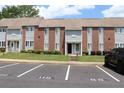Exterior view of brick and vinyl townhouse with lawn and parking, showcasing its exterior design at 636 North Ave # 11E, Jonesboro, GA 30236
