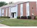 Close-up of a townhouse with a well-manicured lawn and bushes, showcasing its charming appeal at 636 North Ave # 11E, Jonesboro, GA 30236