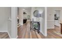 Bright entryway with hardwood floors, console table, and views into the living and dining areas at 115 Township Ct, Woodstock, GA 30189